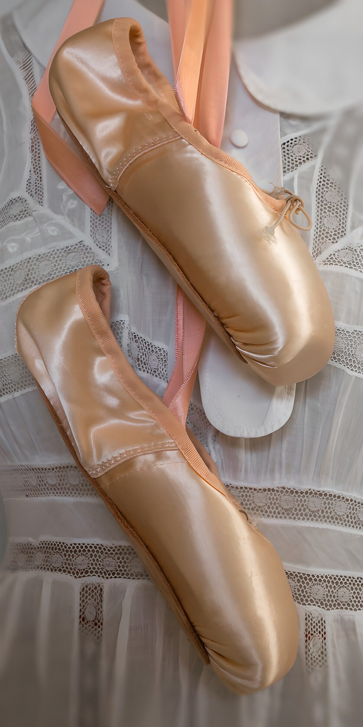 Pink satin pointe shoes at rest