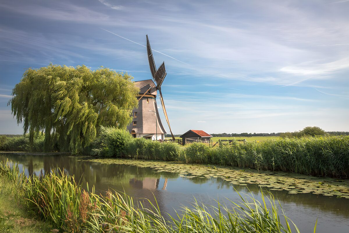 Windmill beside a quiet waterway