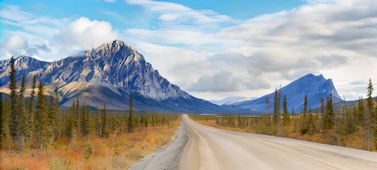 An empty road through autumn mountains