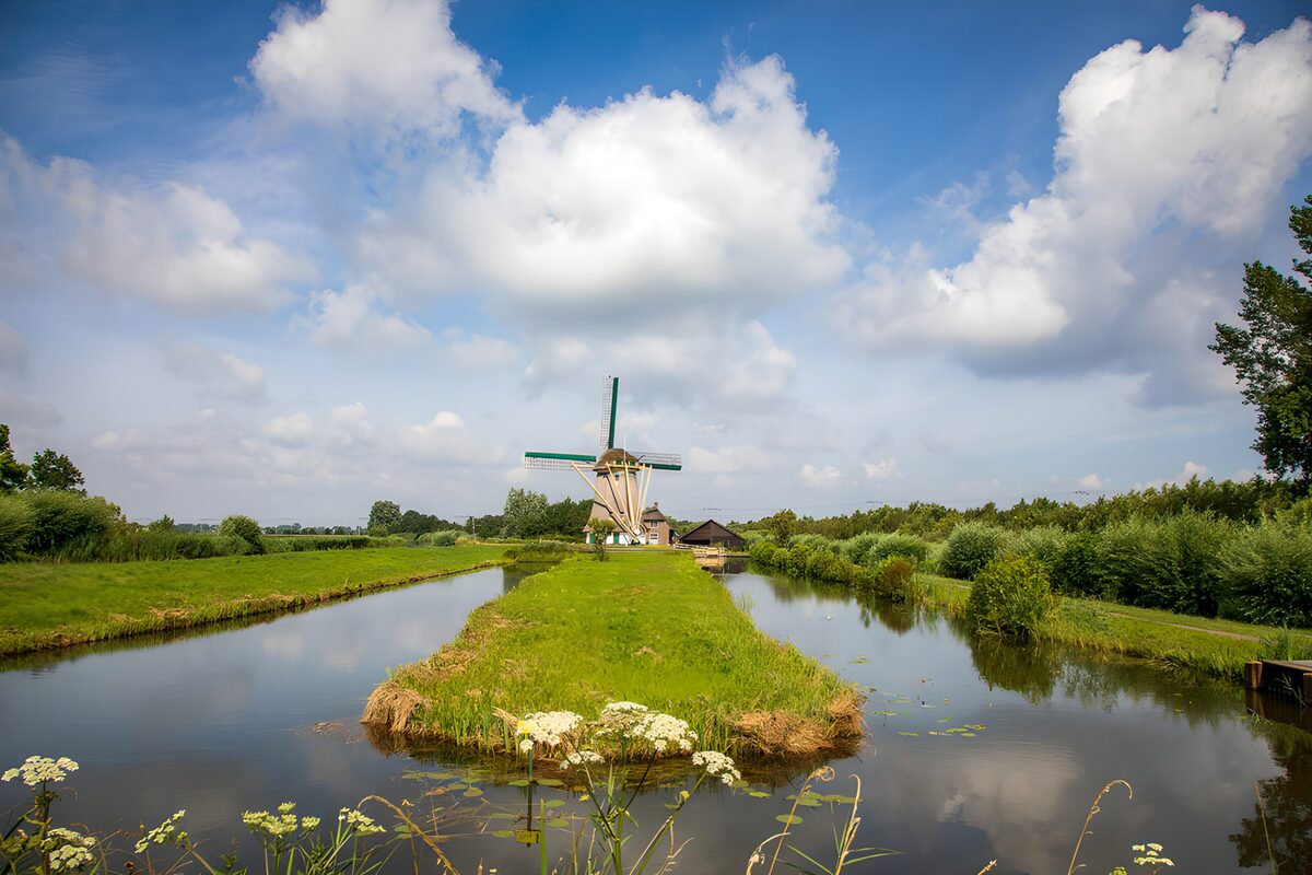 Windmill between sunlit waterways