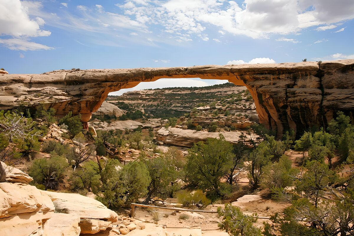 Sunlit rock bridge over a rugged ravine