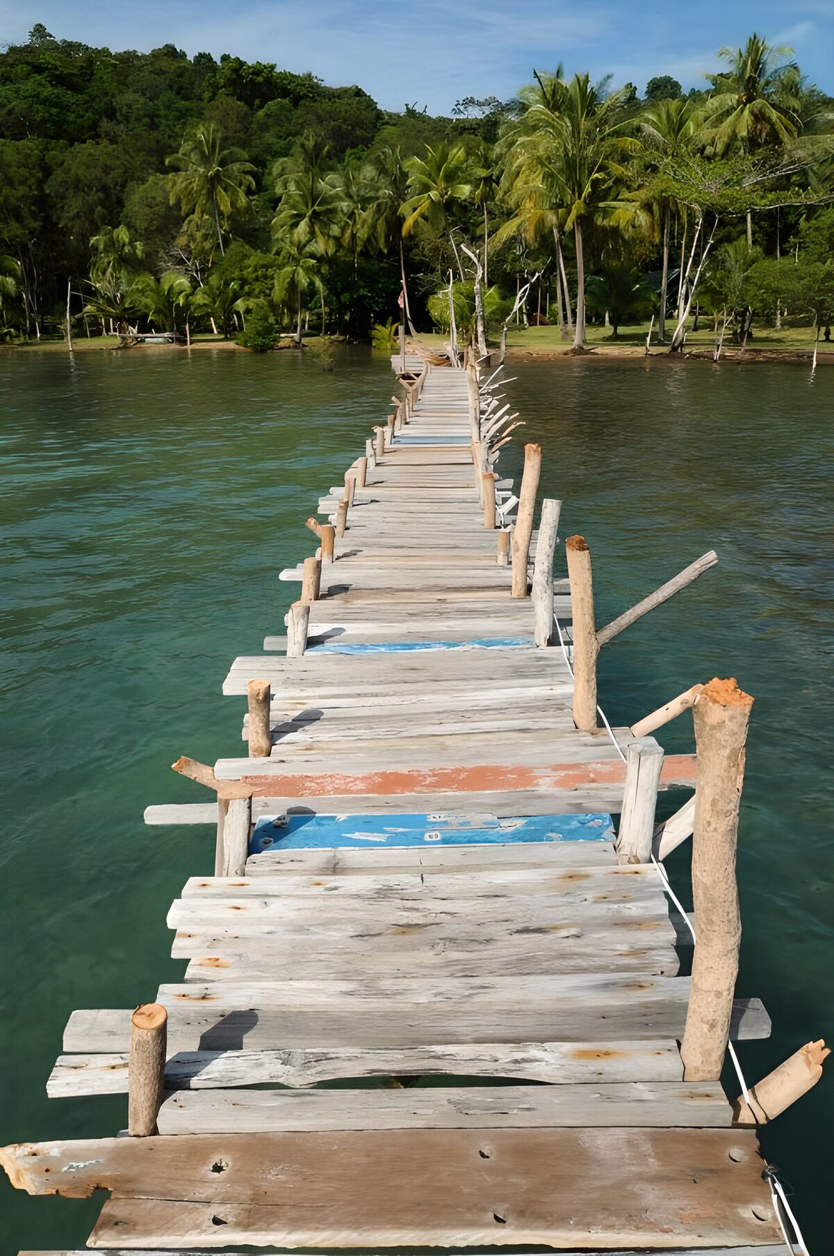 Rustic jetty to a quiet tropical shore