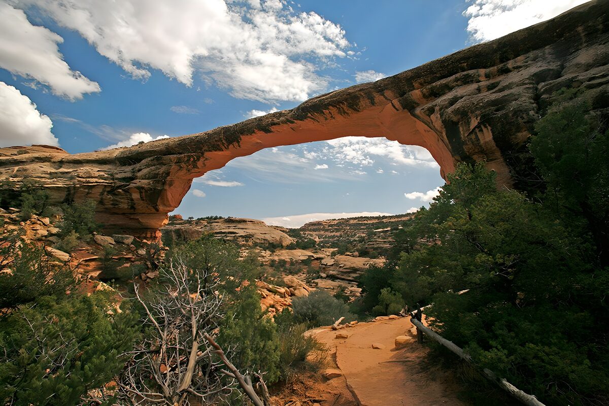 Sunlit rock arch over a rugged canyon