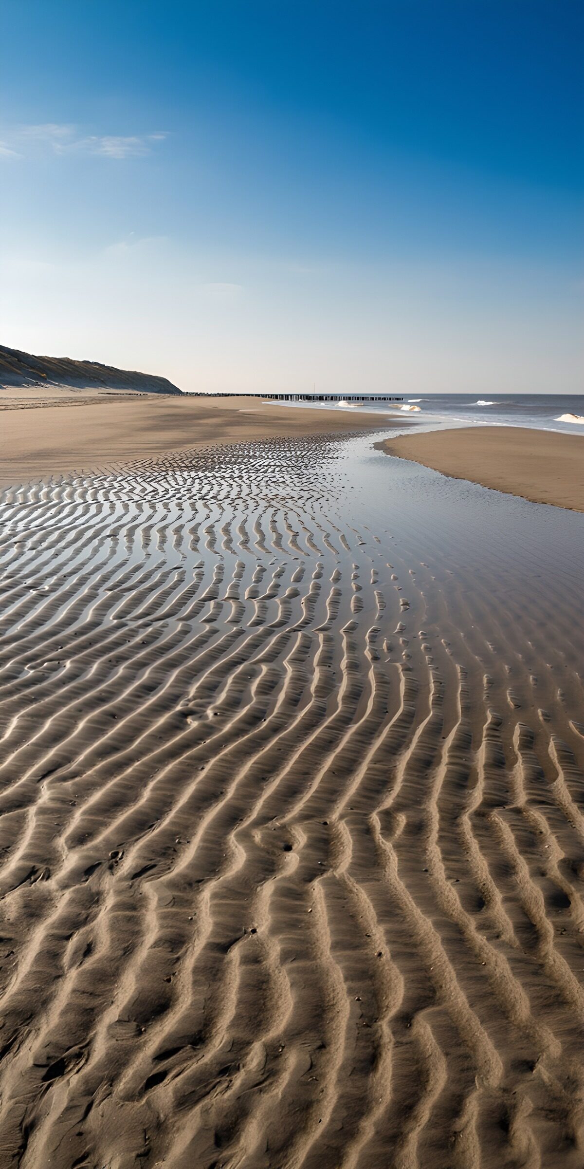 Rippled sand and a quiet sea