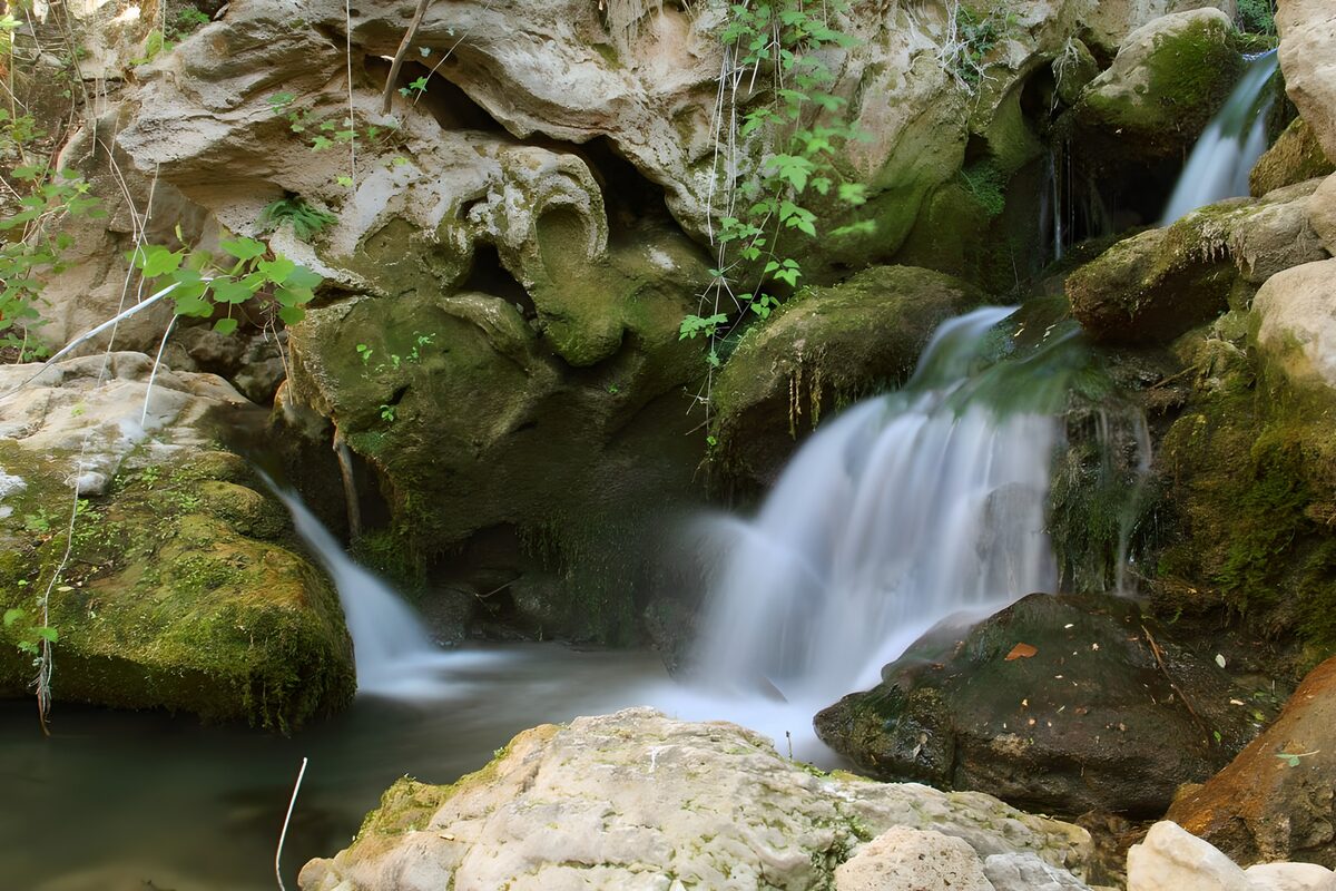 Small waterfall over moss-covered rocks