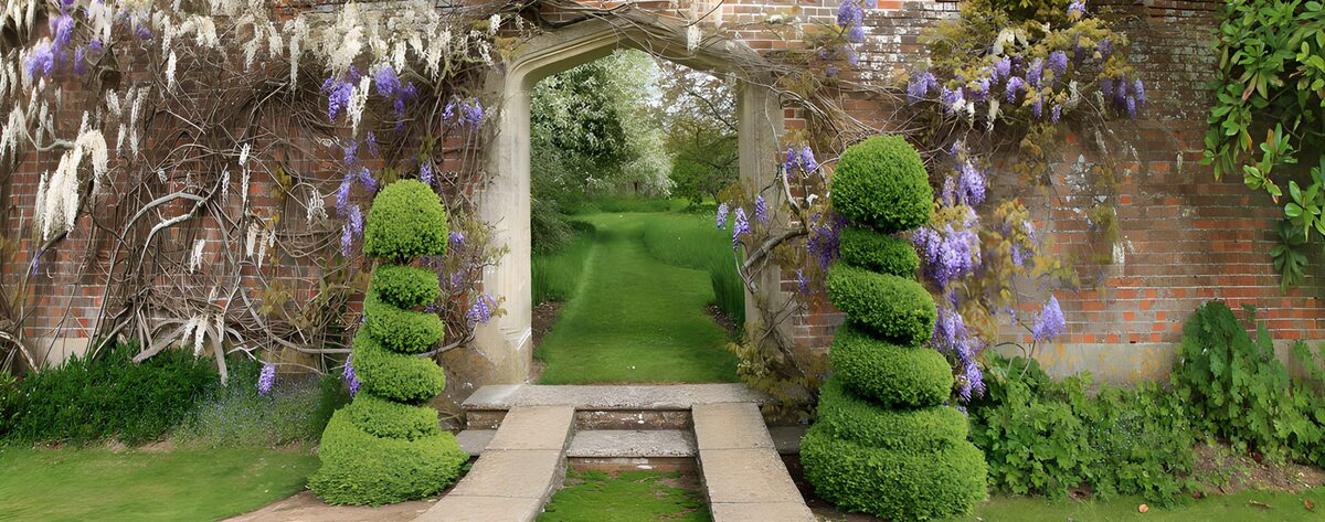 Stone arch and topiary in spring