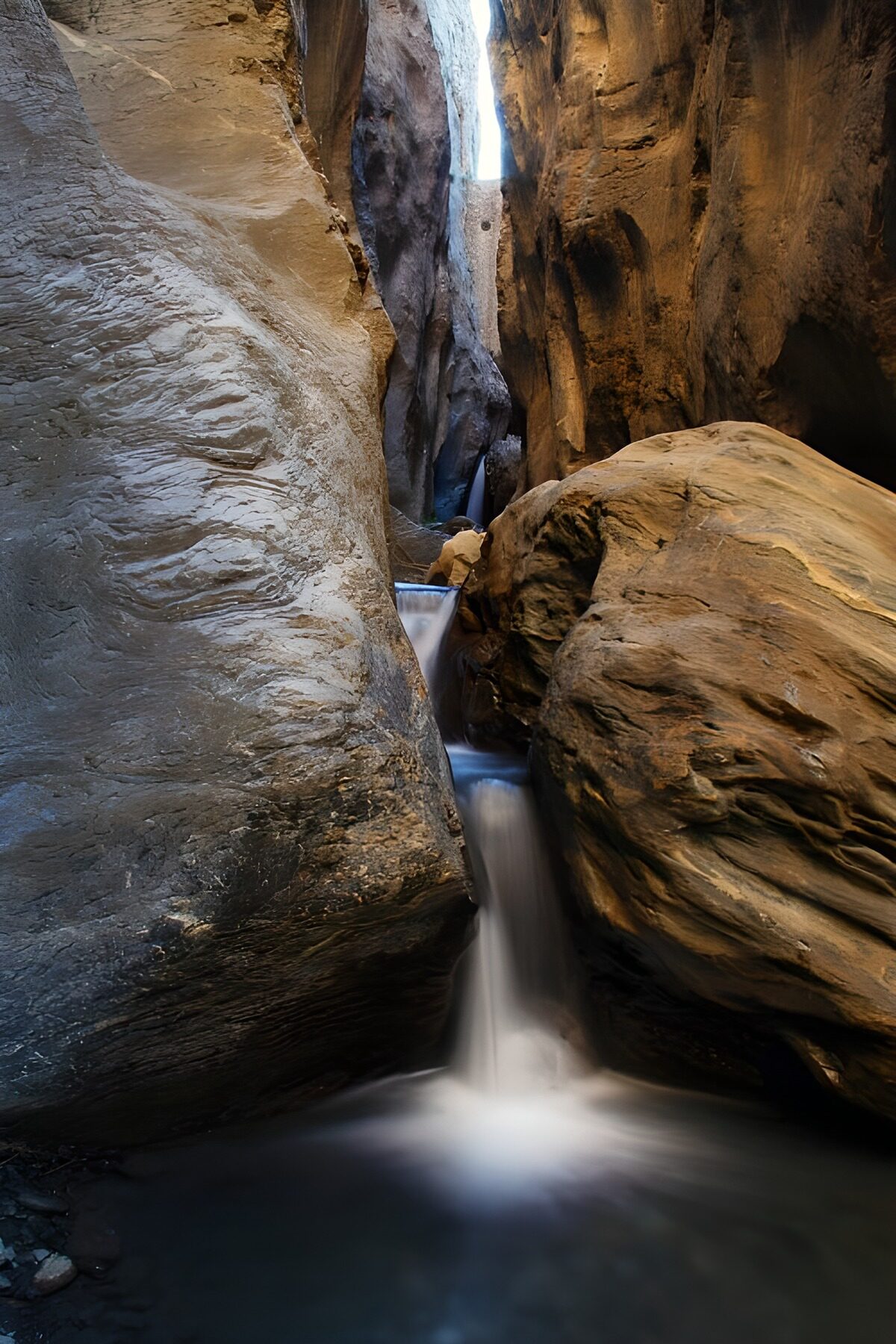 Waterfalls in a shadowy rock gorge