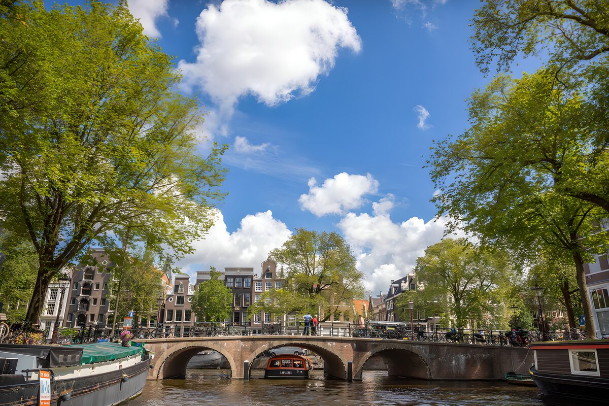 White clouds sail over the canal