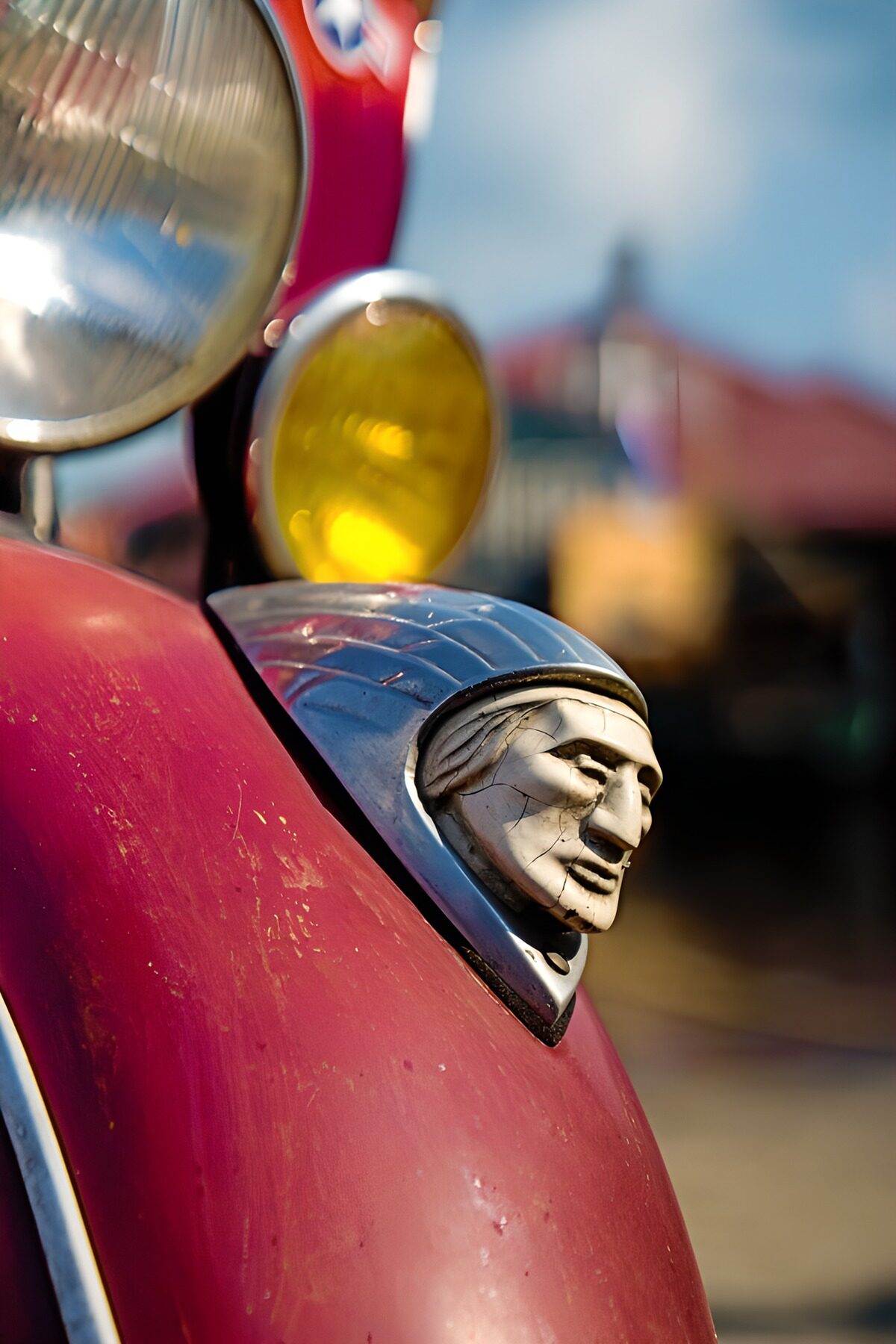Red scooter with a weathered sculpted face