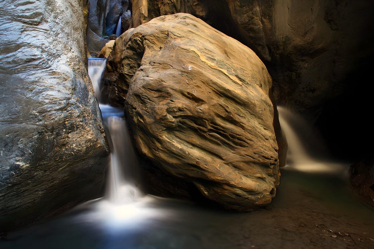 Small waterfalls in a shadowed gorge