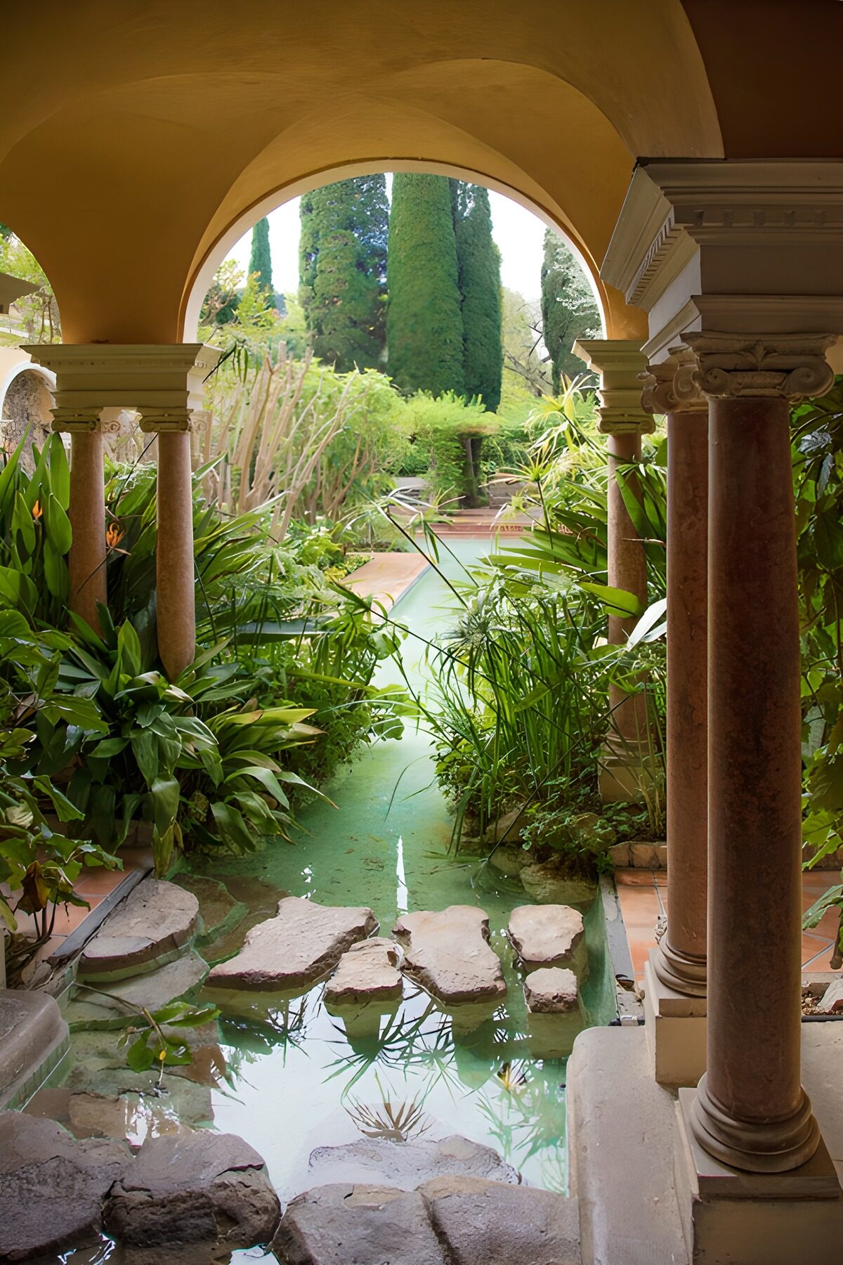 Garden pond through an ochre arch