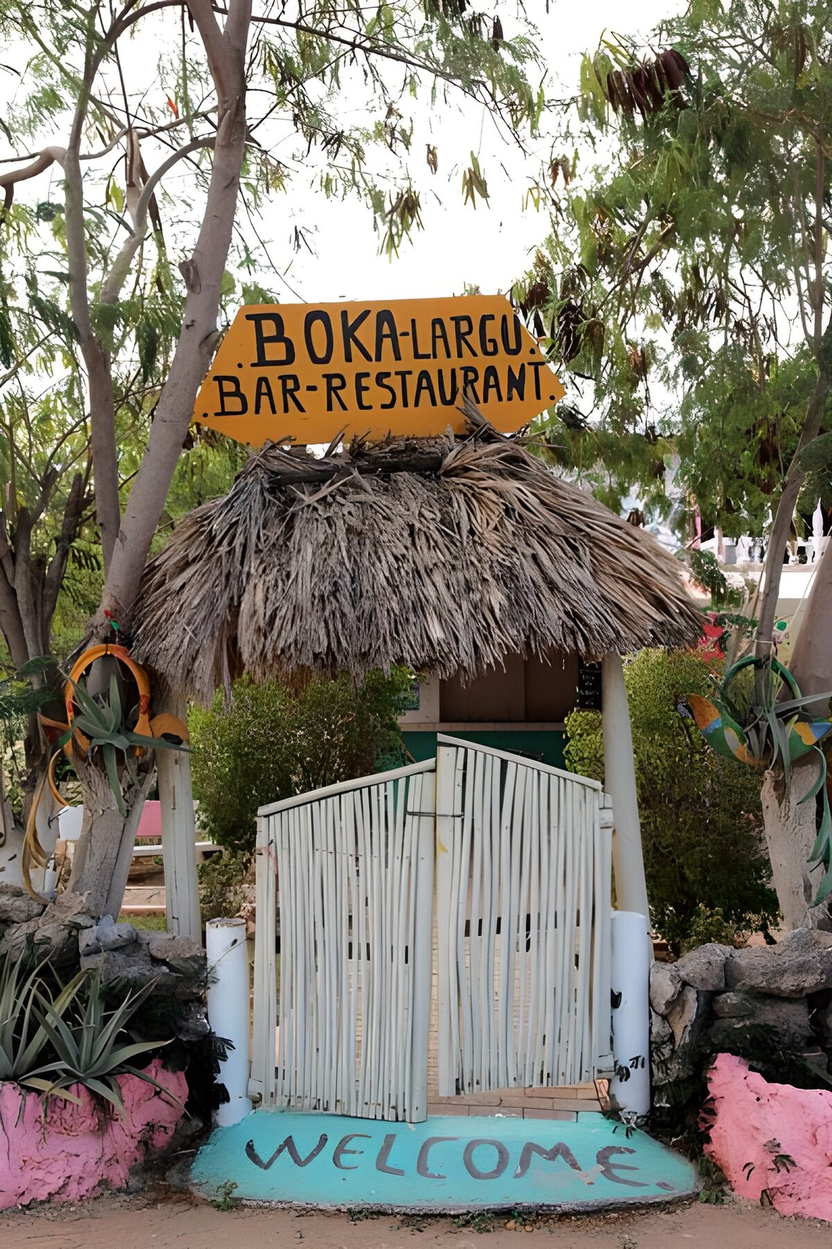Leafy entrance to a thatched bar