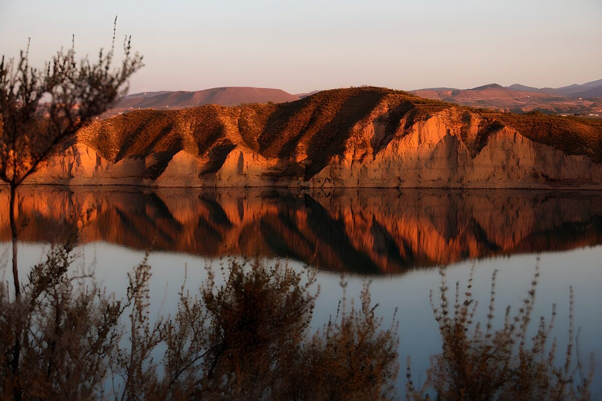 Golden cliffs reflected in still water
