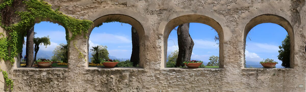 Four weathered arches and garden flowers