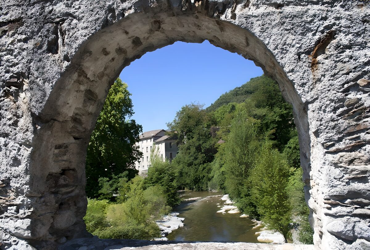 River view through a sunlit stone arch