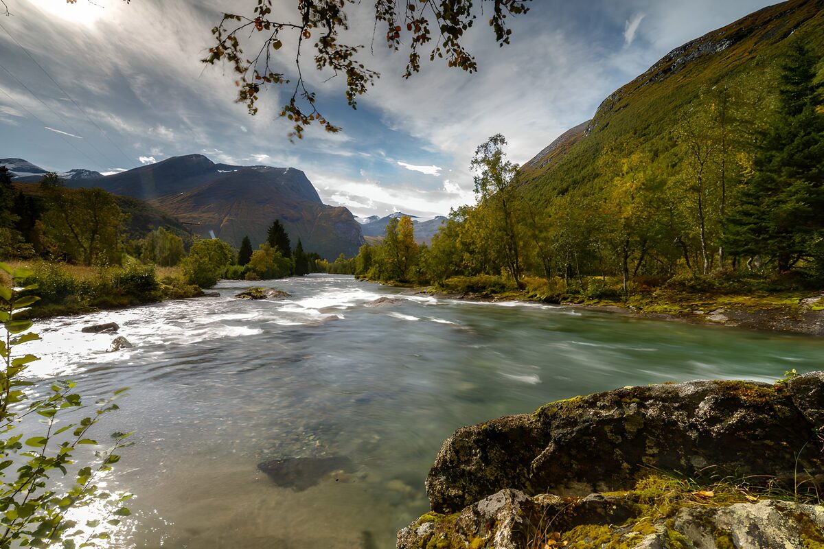 Fast-flowing river in an autumn valley