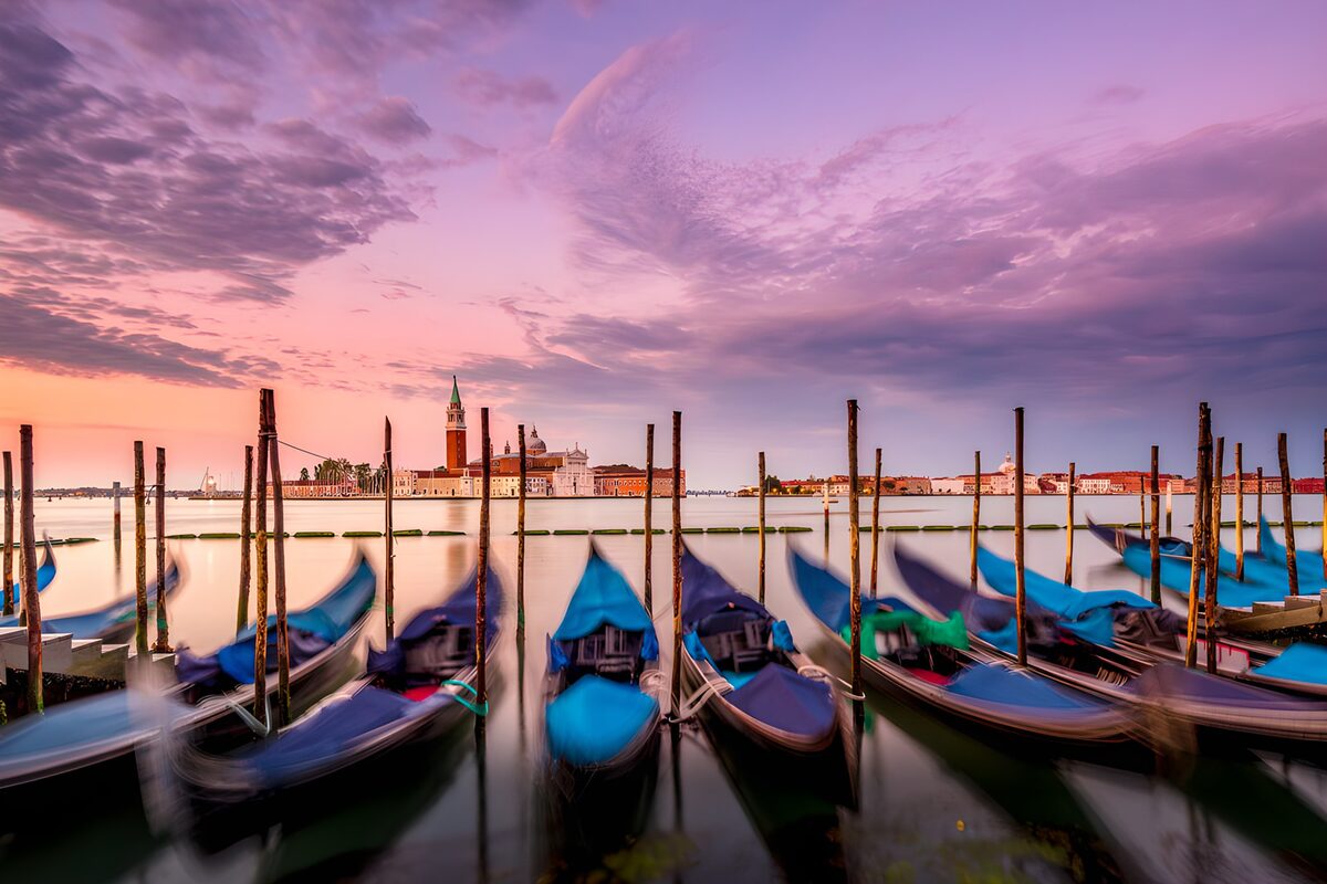 Gondolas beneath a pink evening sky