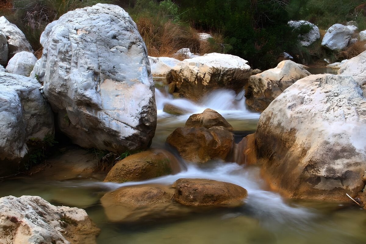 Silky stream between pale boulders