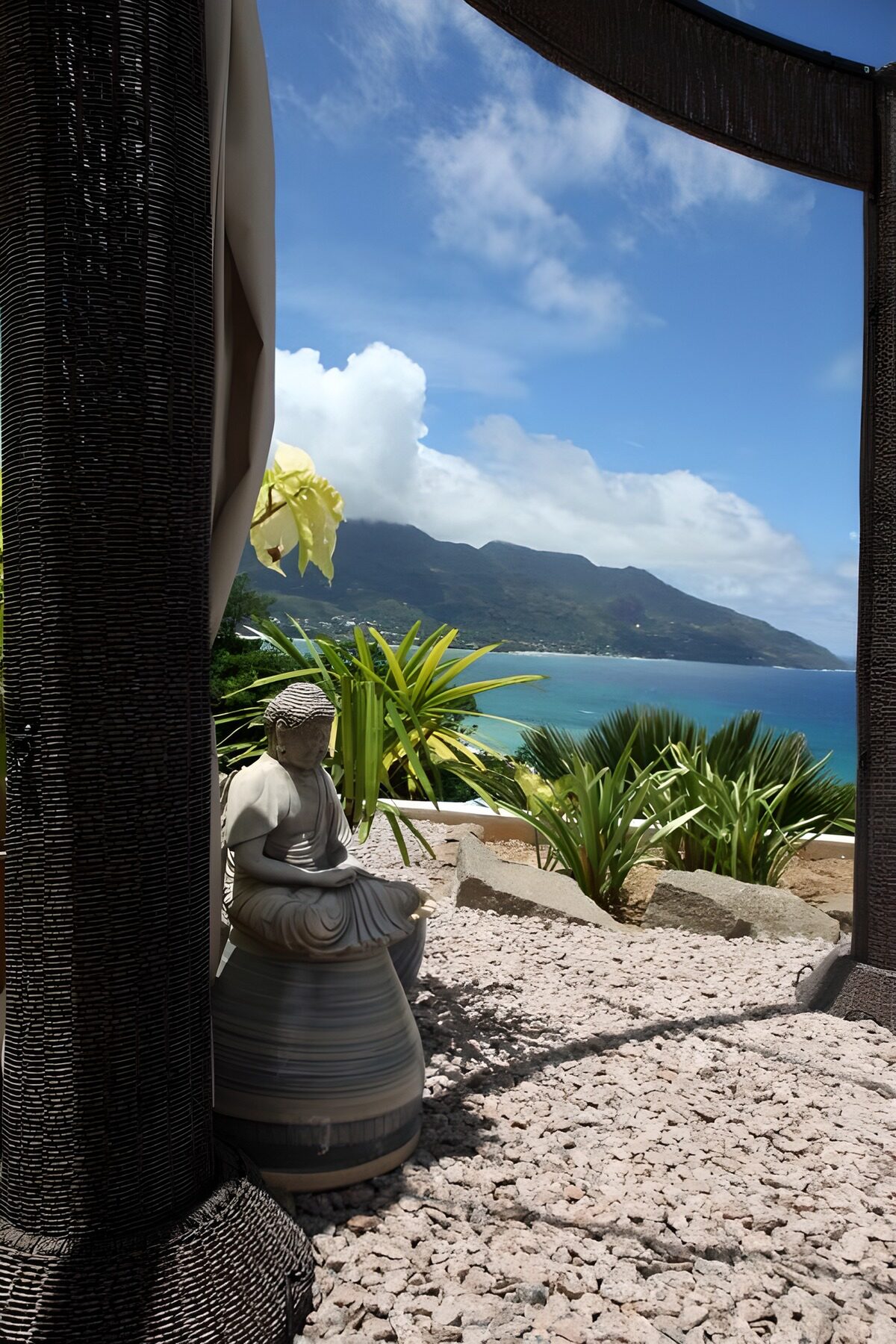 Buddha overlooking a sunlit bay