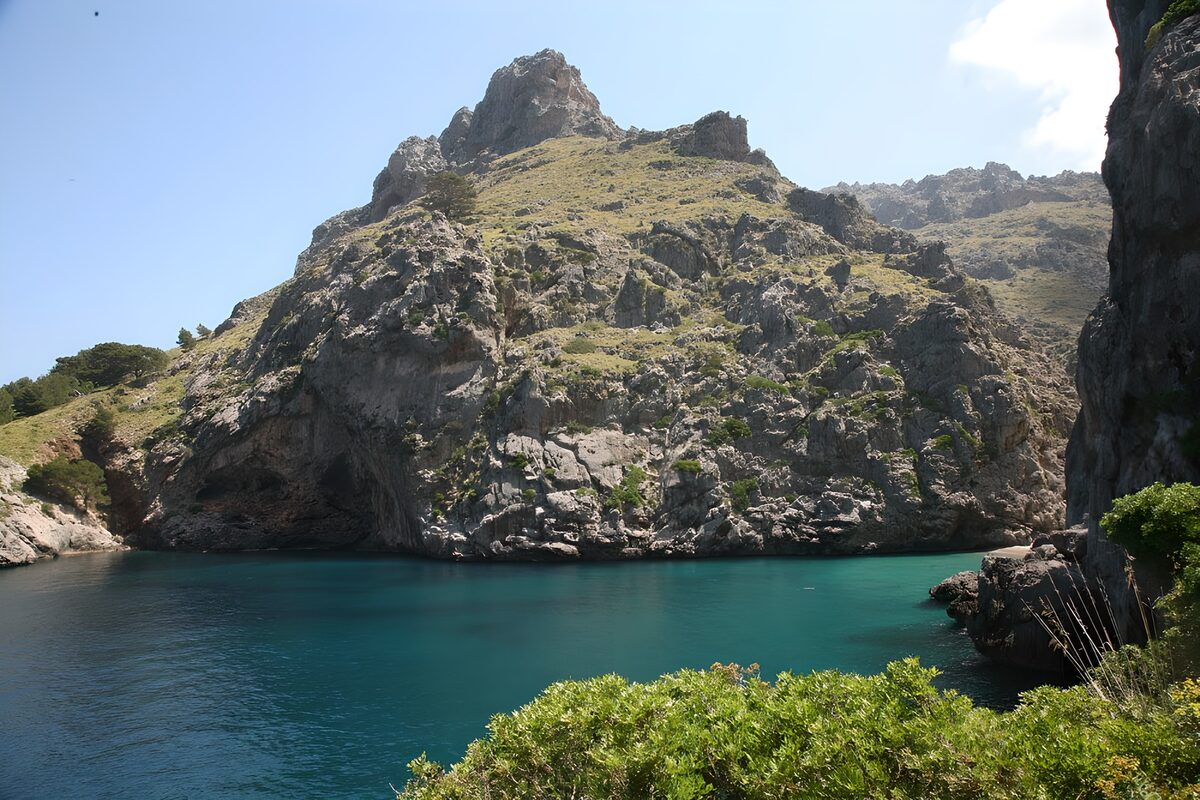 Sheltered turquoise water beneath cliffs