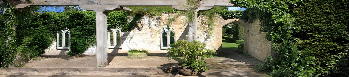 Sunlit stone courtyard with a pergola