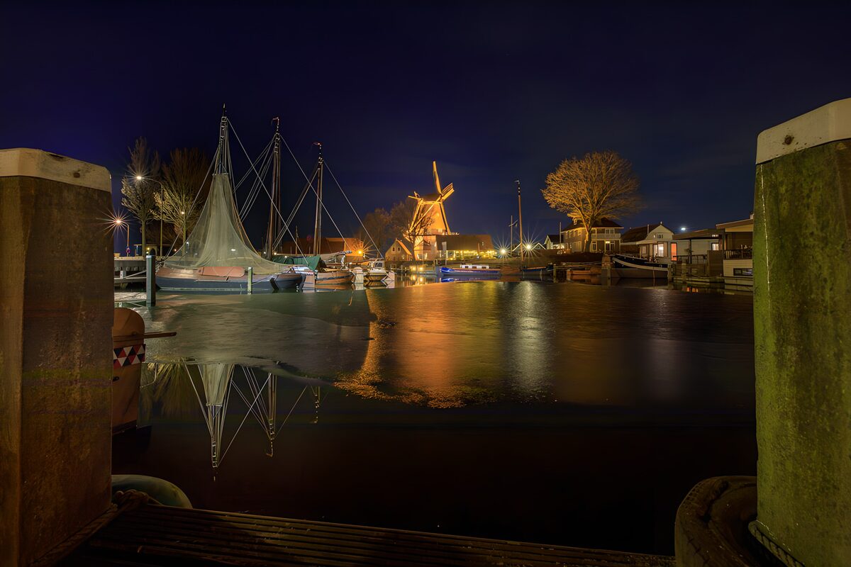 Windmill and sailboats after dark