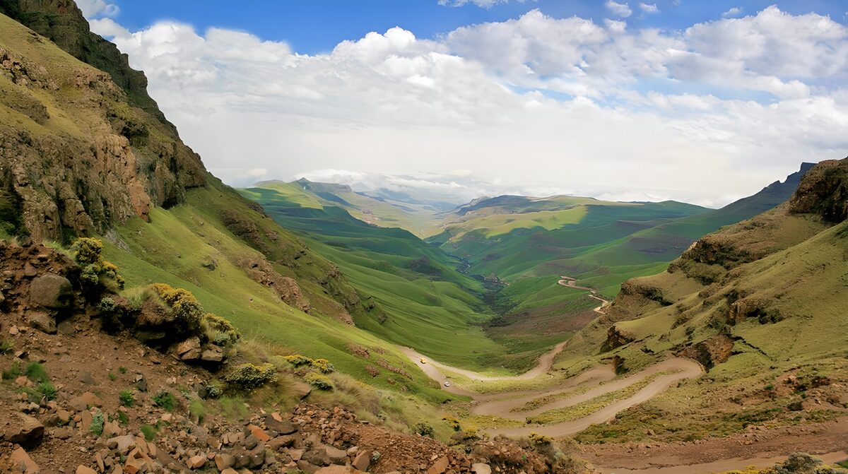 Winding dirt road through a vast valley
