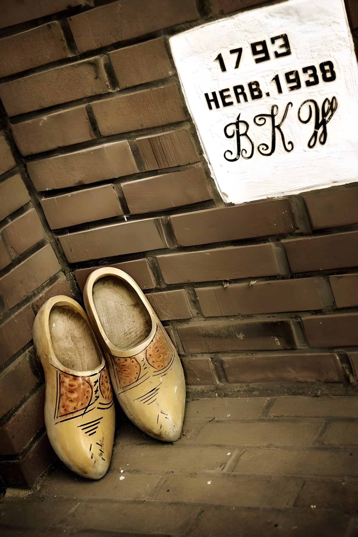 Decorated clogs against warm brick