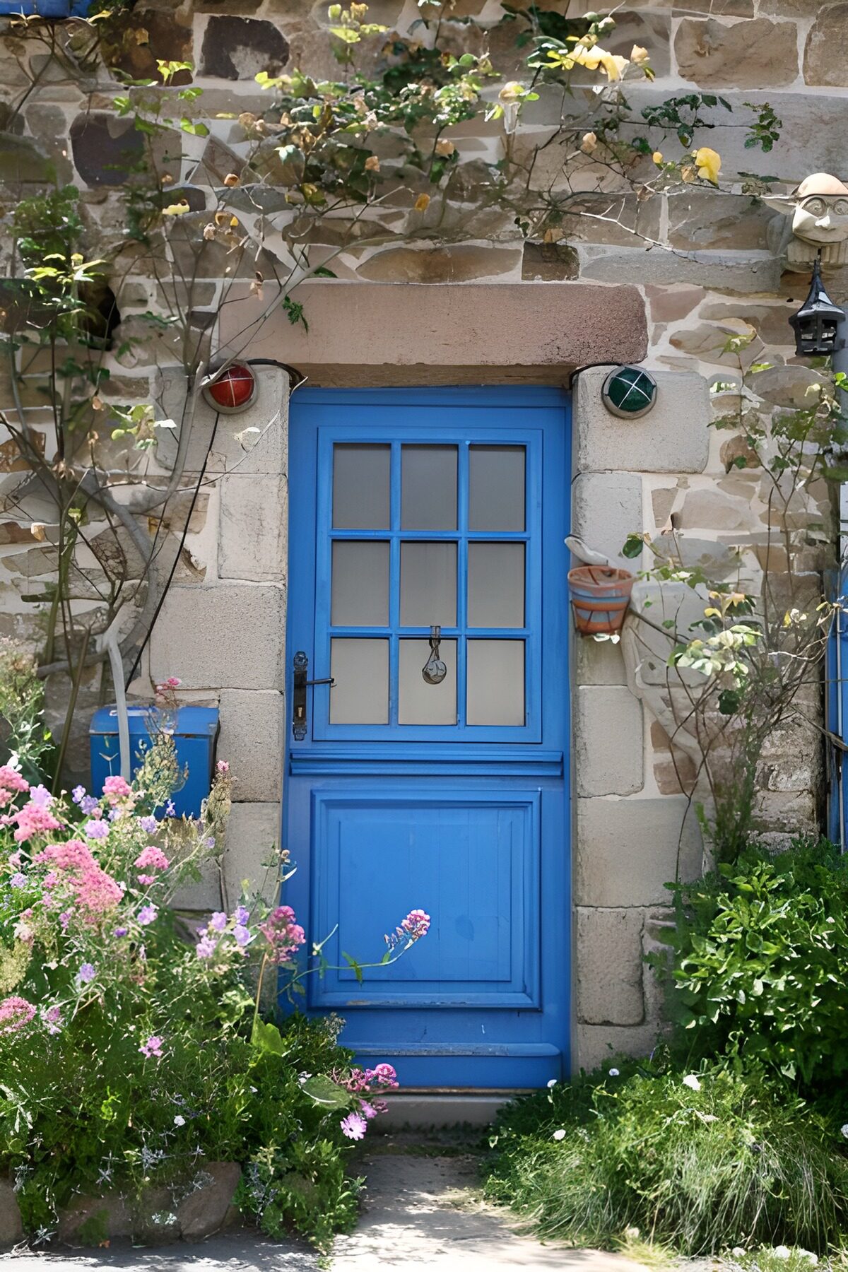 Blue door in a sunlit flower garden