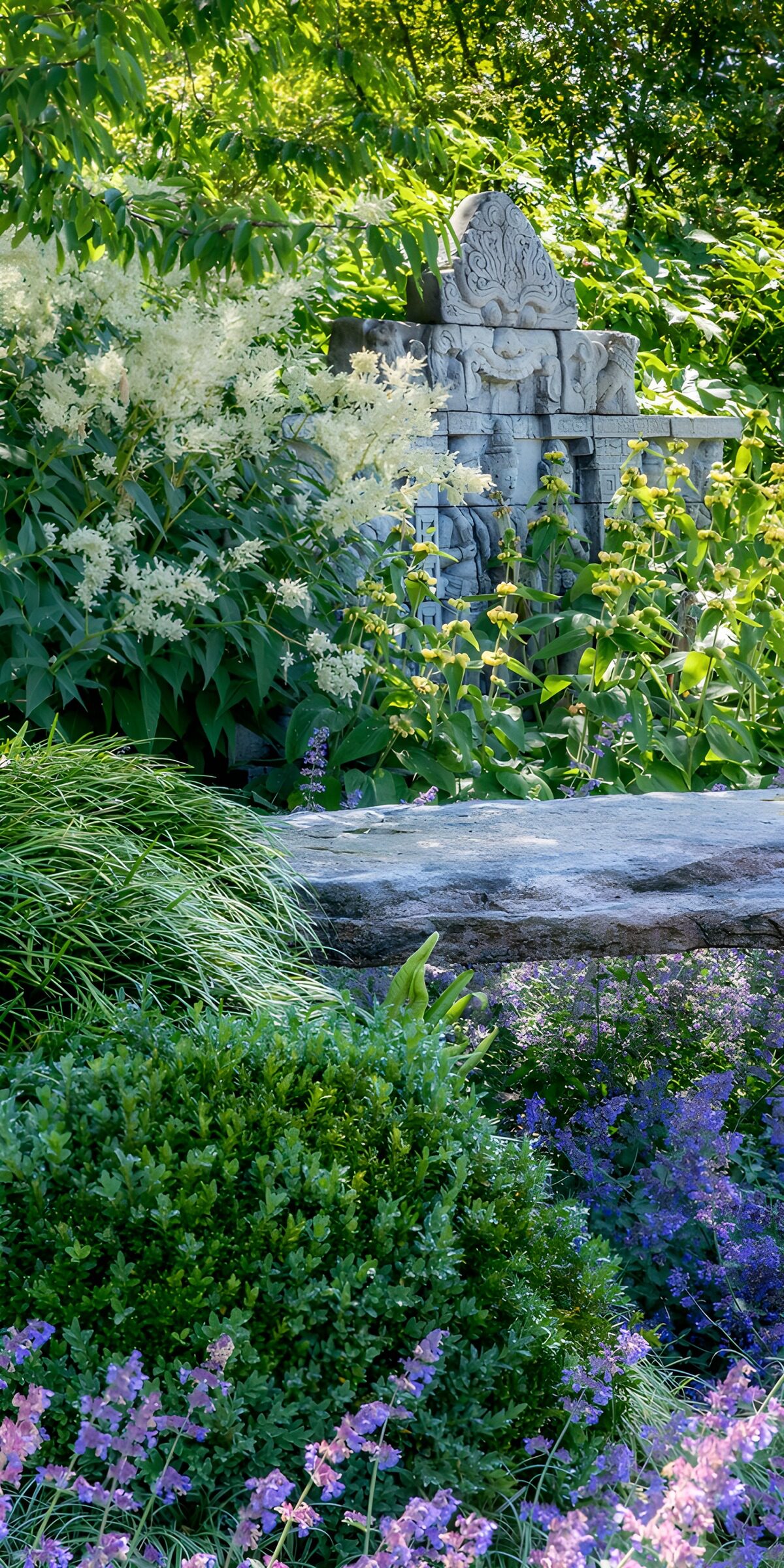 Stone carving in a sun-dappled garden