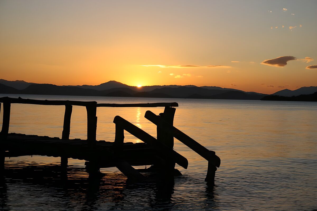 Wooden pier over a lake at sunset