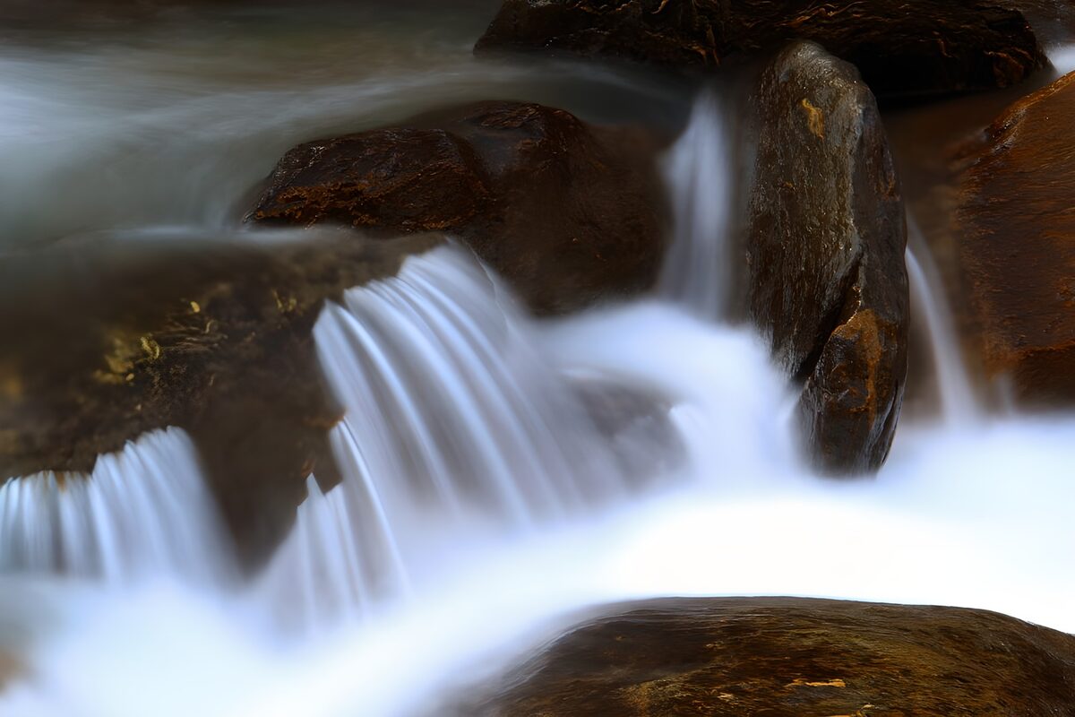 Silky cascades over dark rocks