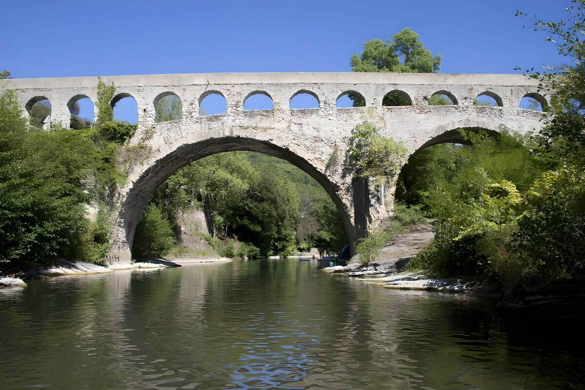 Stone bridge over a sunlit river