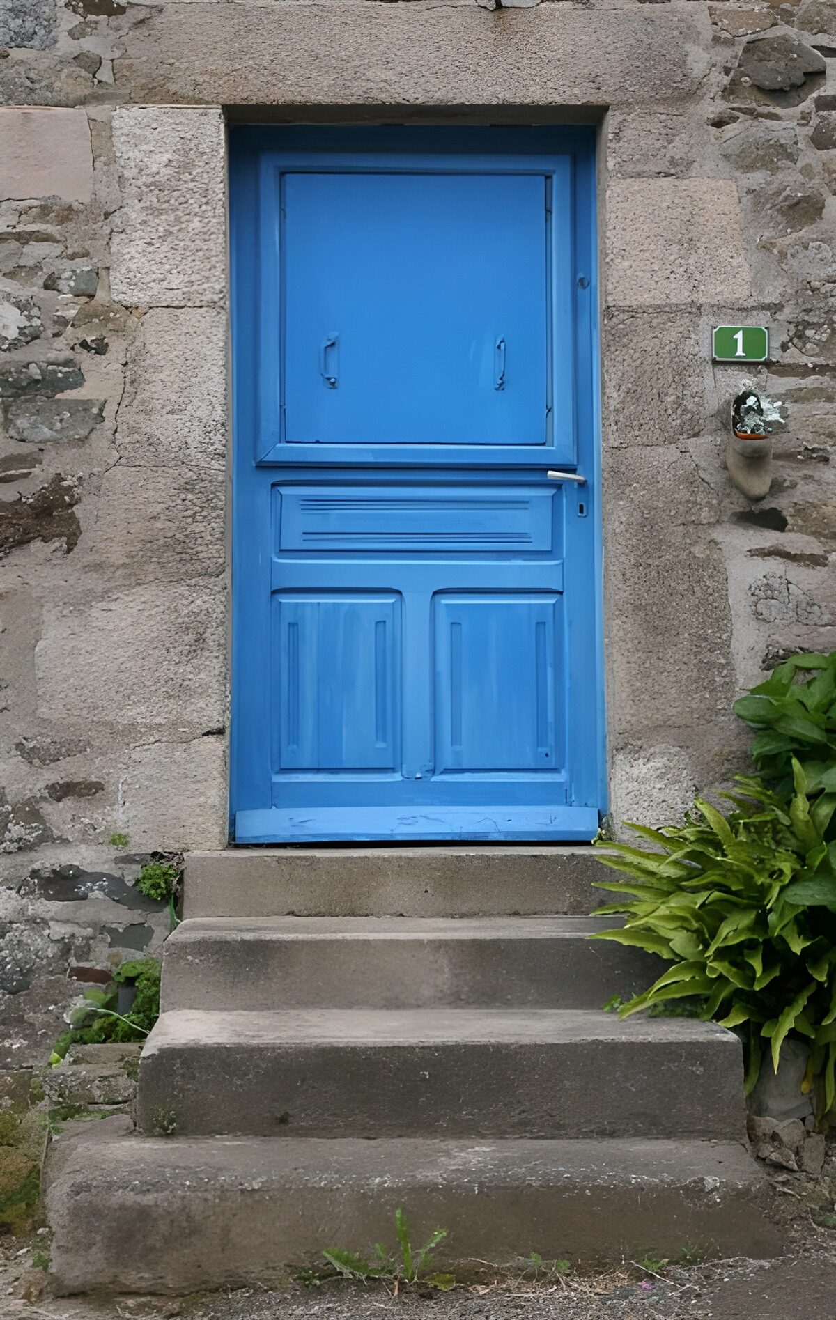 Blue door above weathered stone steps