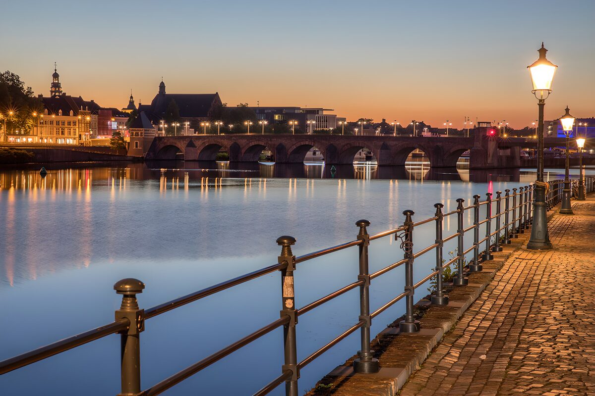 Stone arches over the river at dusk