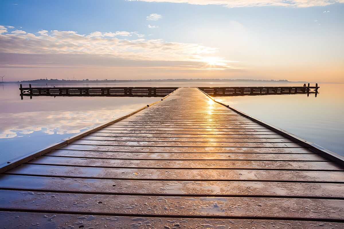 Wooden jetty in golden lake light