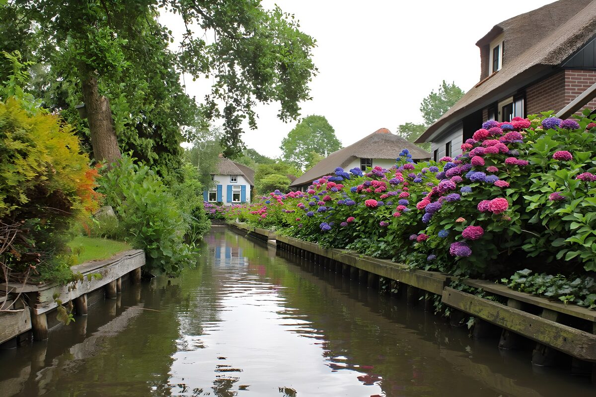 Thatched houses beside a quiet canal