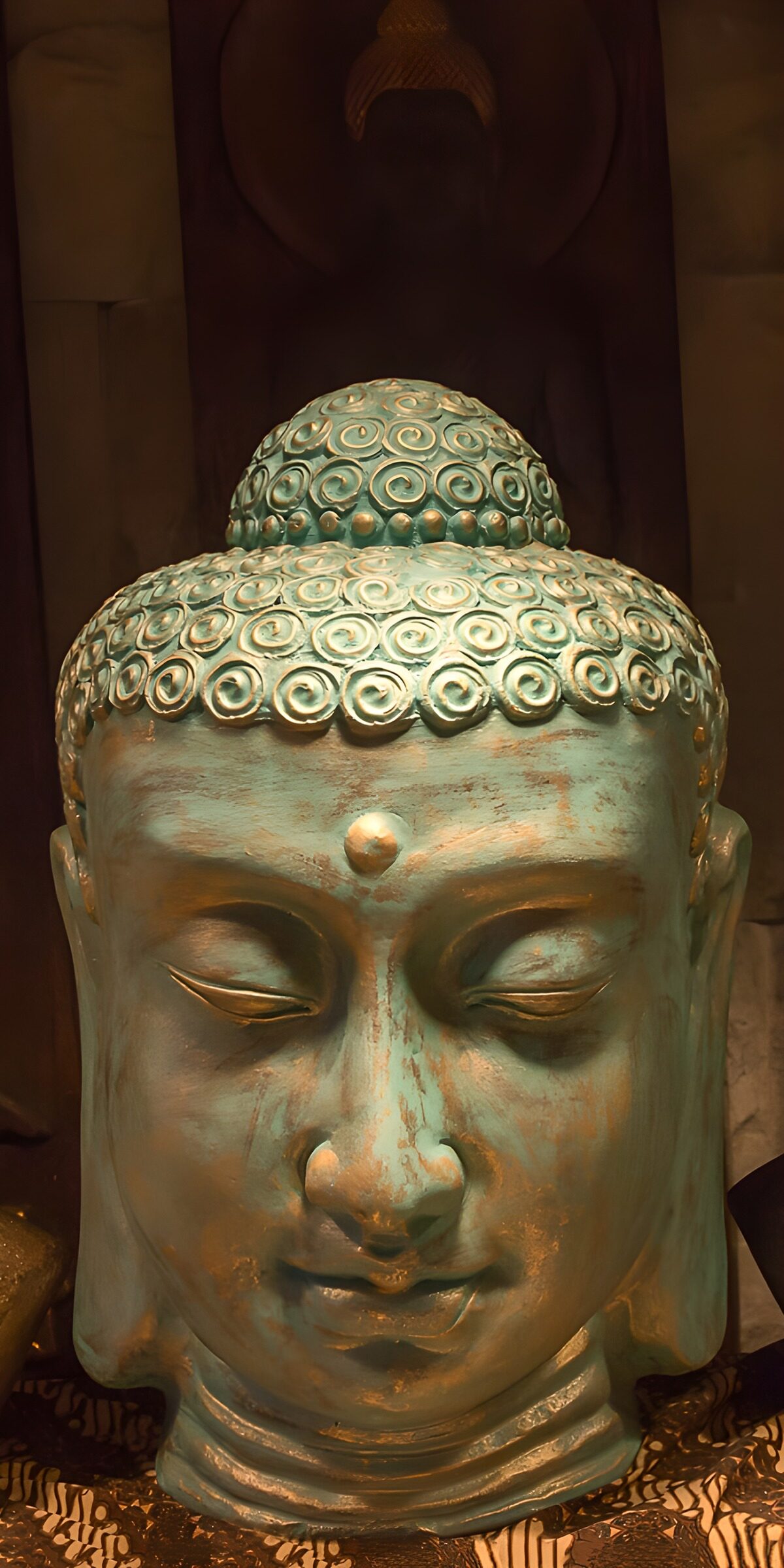 Turquoise Buddha head in warm light