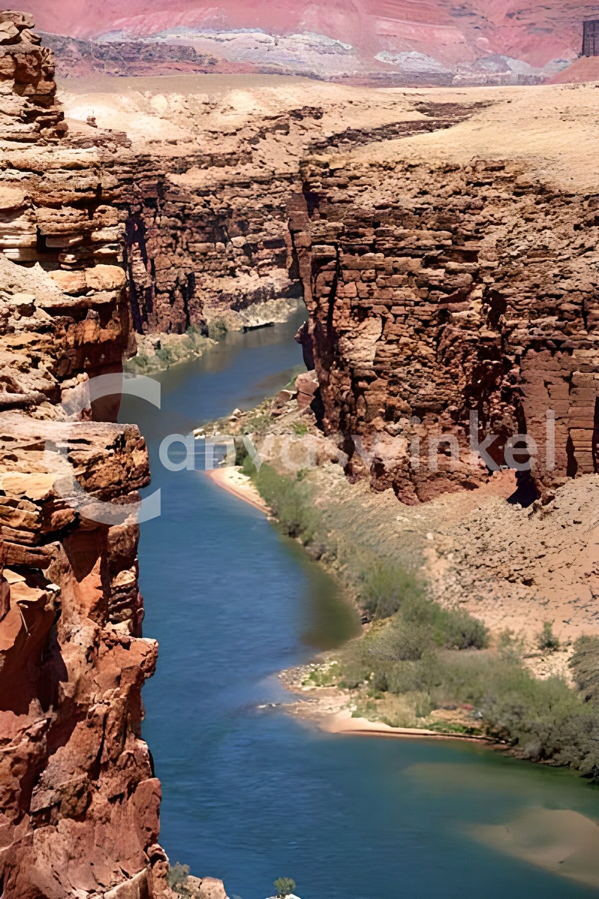 Blue-green river between sun-baked cliffs