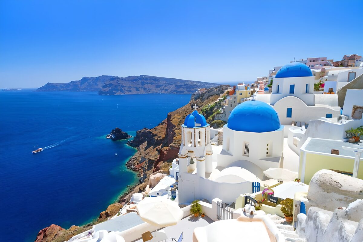 Blue-domed churches above the sunlit sea