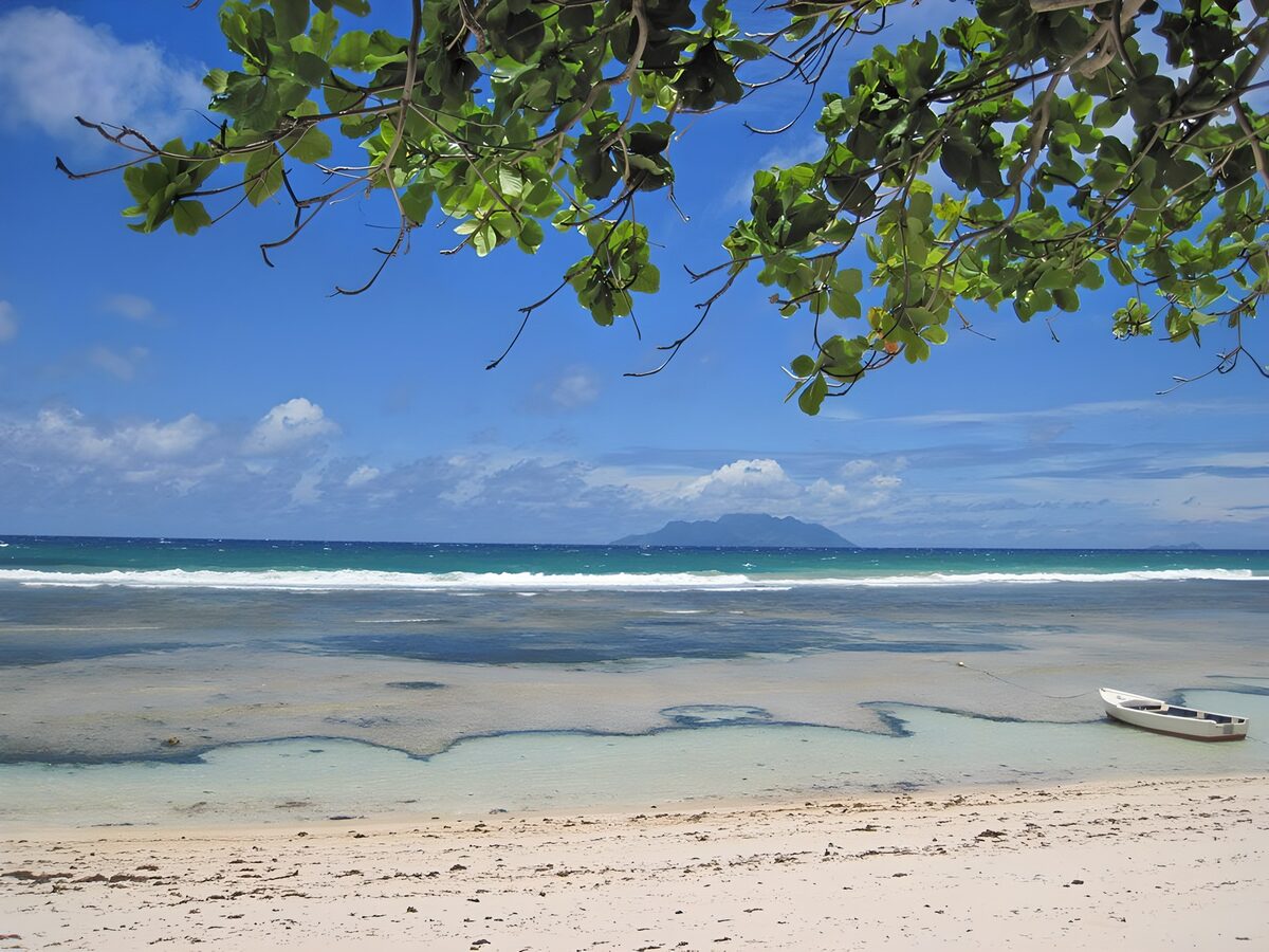 White boat on a sunlit tropical beach