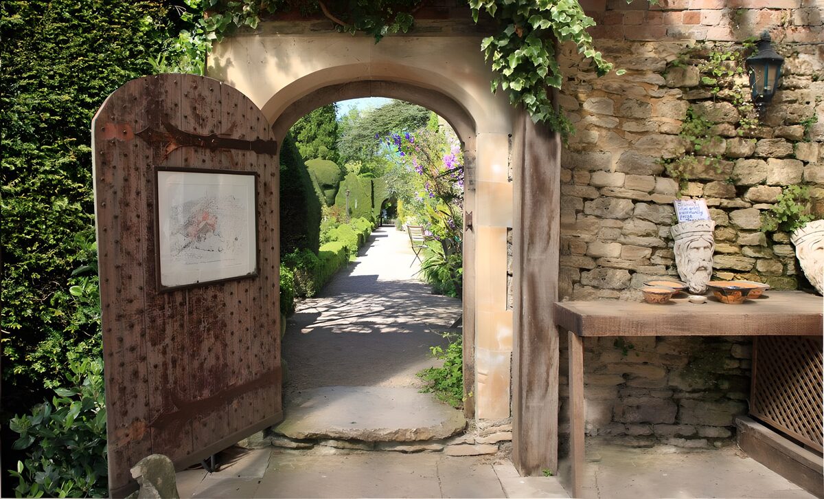 A stone arch frames a greener world