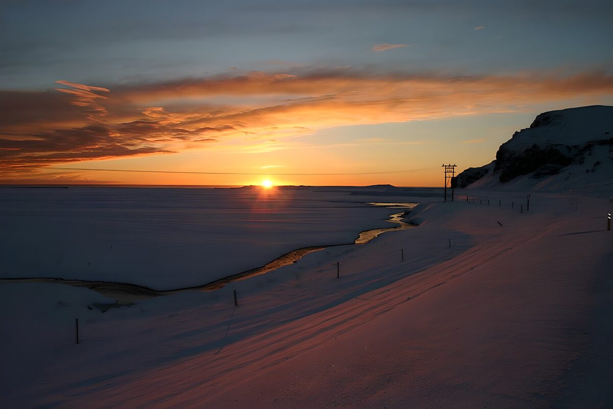 Snow-covered coast at sunset