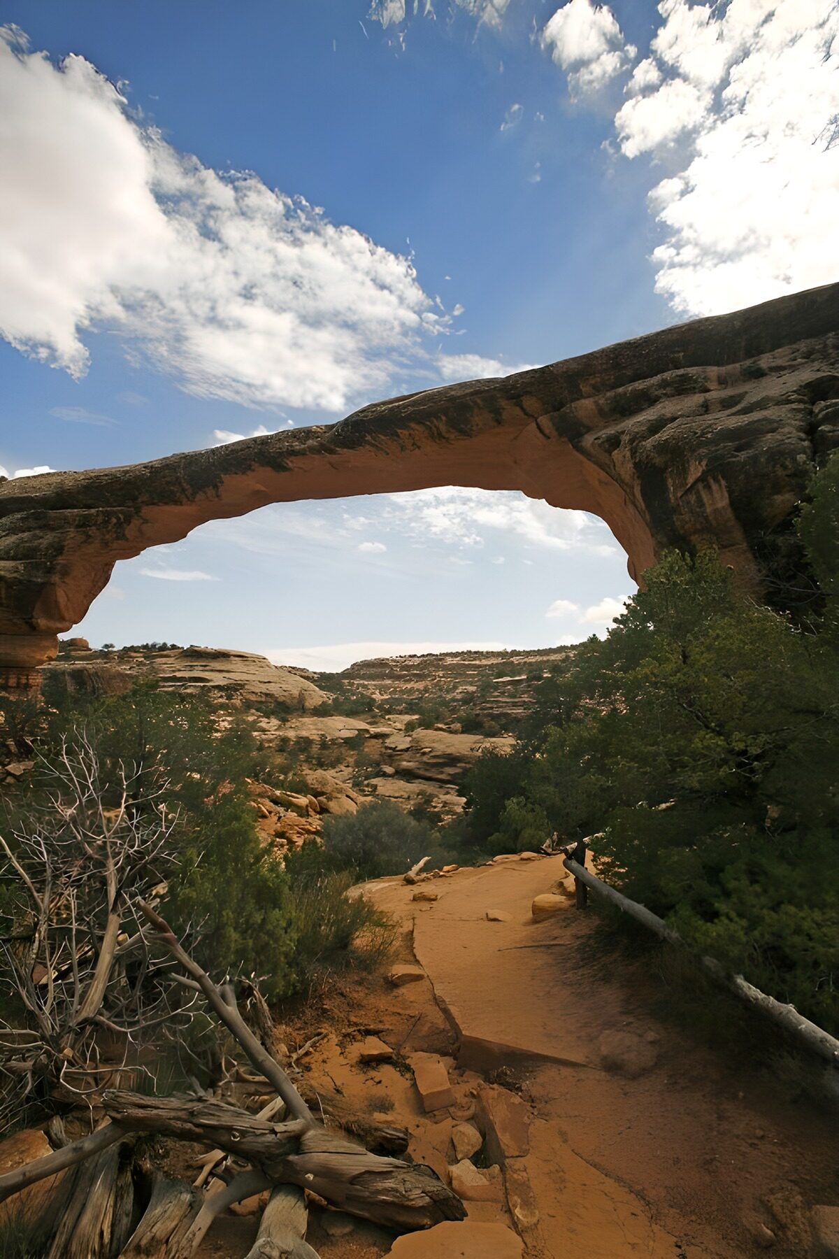 Orange rock arch beneath a blue sky