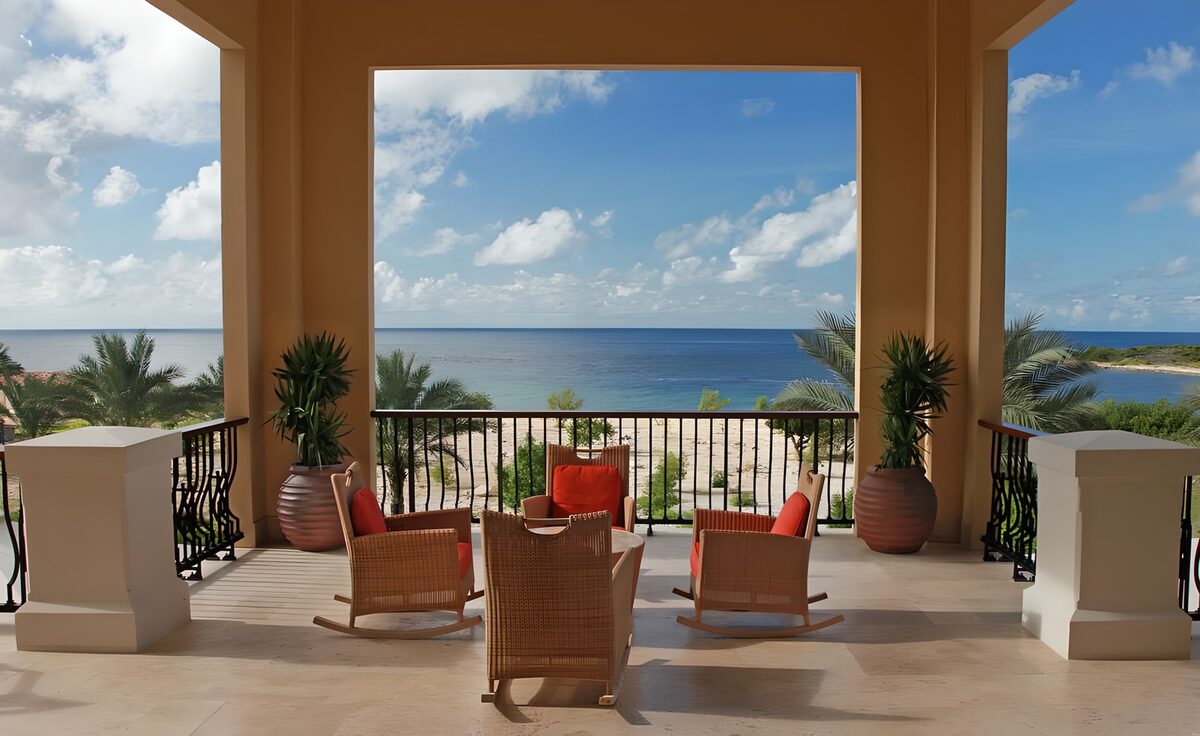 Rocking chairs on a sunlit sea-view terrace