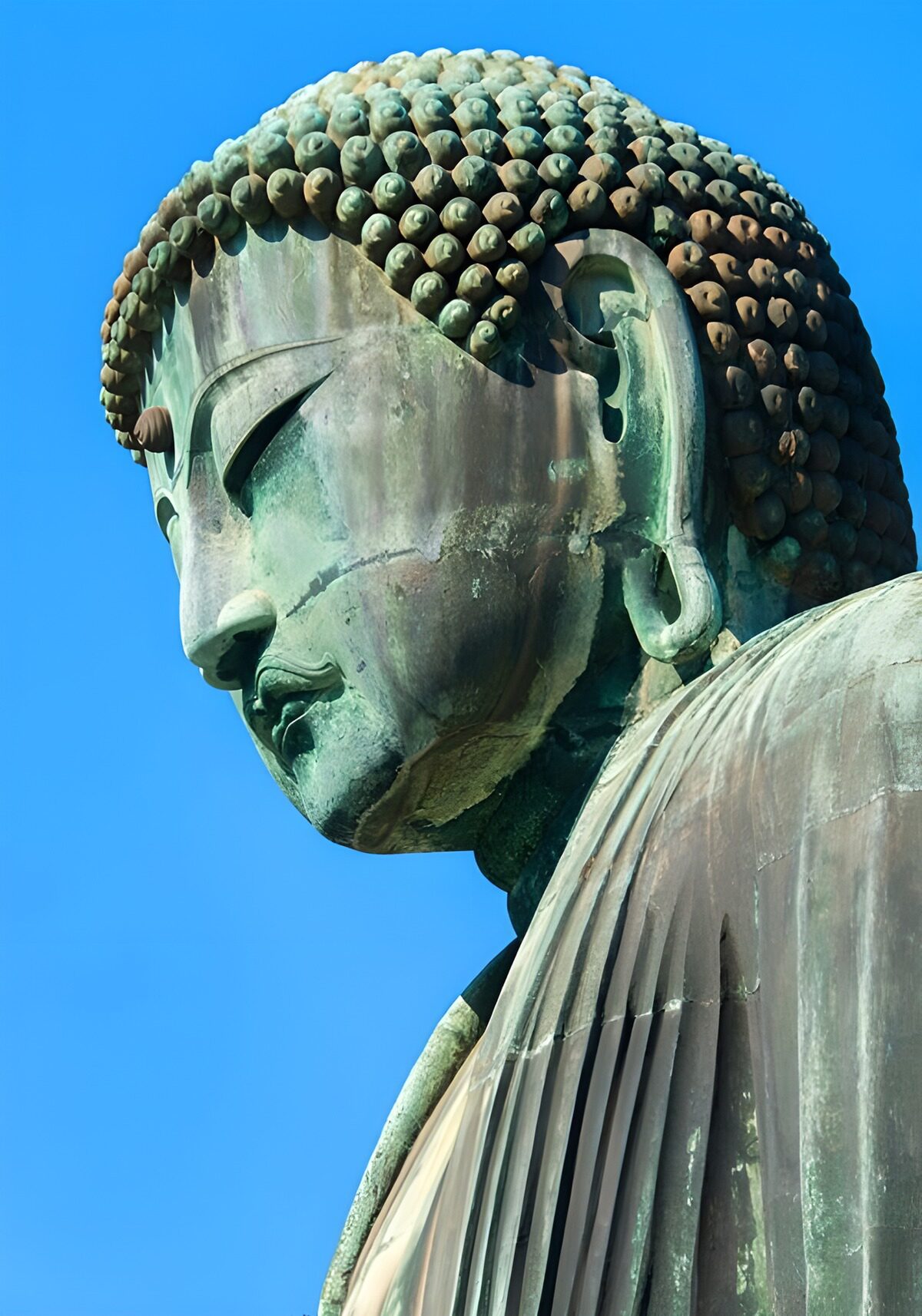 Weathered bronze Buddha in the sun