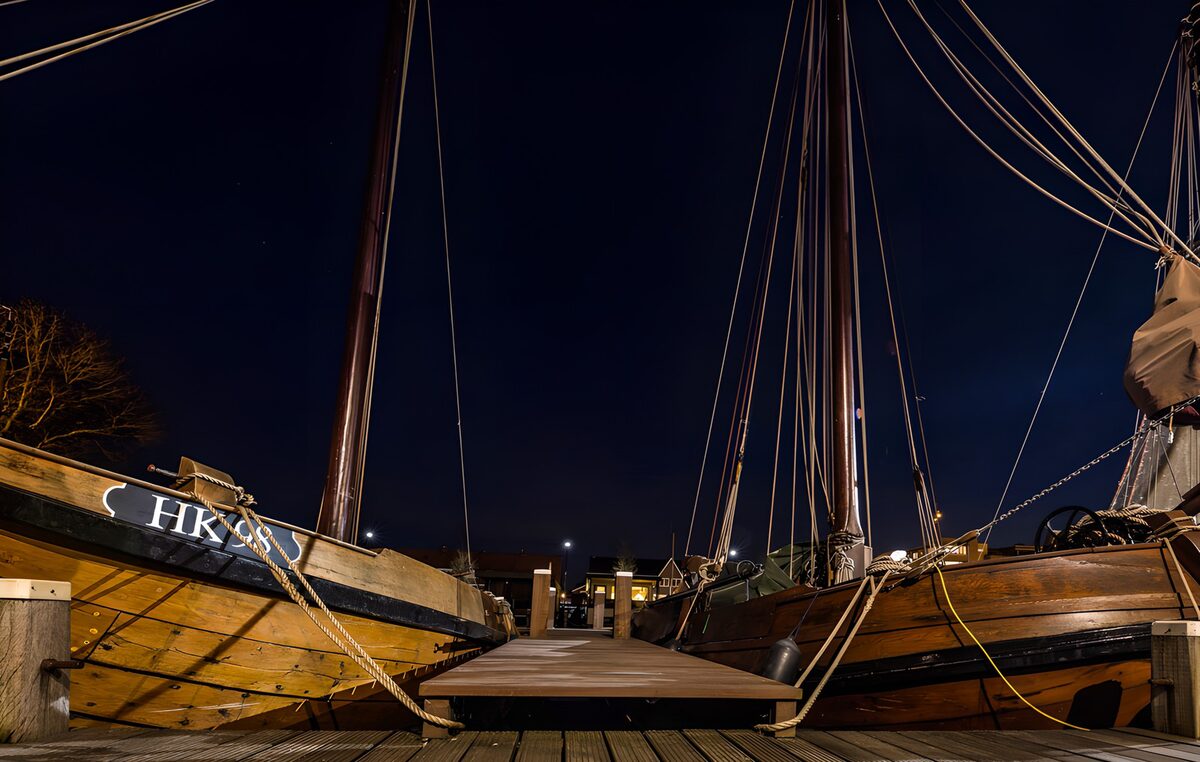 Wooden sailing boats moored at night