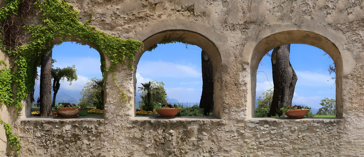 Three stone arches overlooking a garden