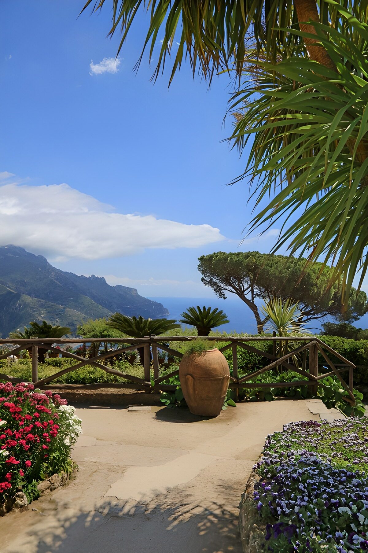 Sunlit flower terrace above the blue sea