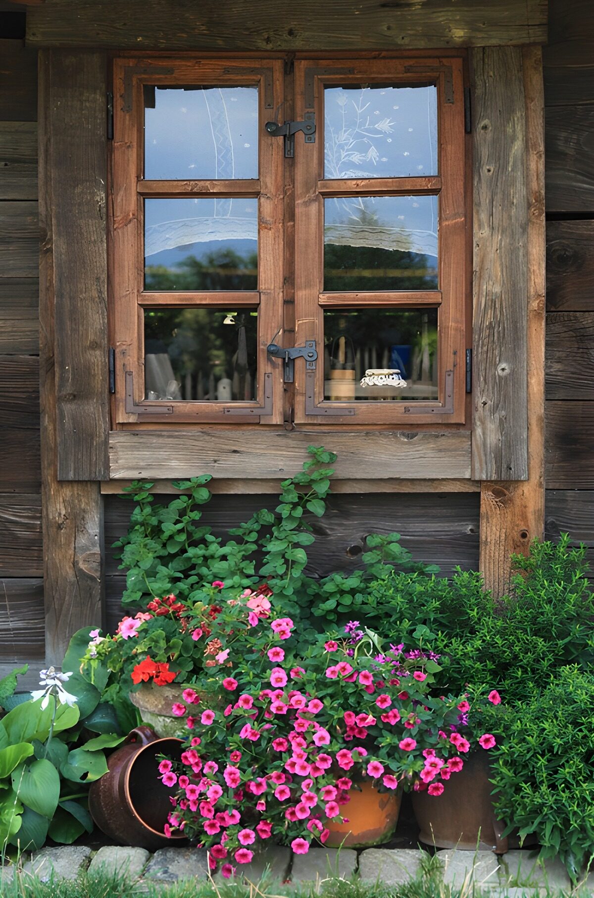 Rustic wooden window with pink flowers
